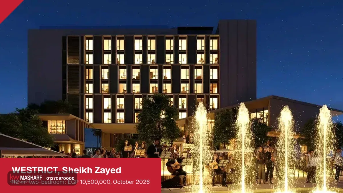 Evening plaza with lit fountains and people gathered in front of a hotel block