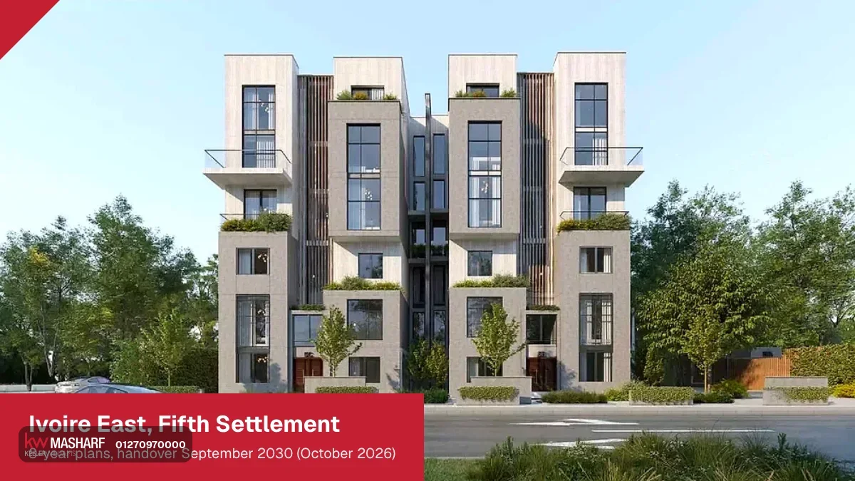 Four-storey residential building with tall windows and planted balconies on a tree-lined street